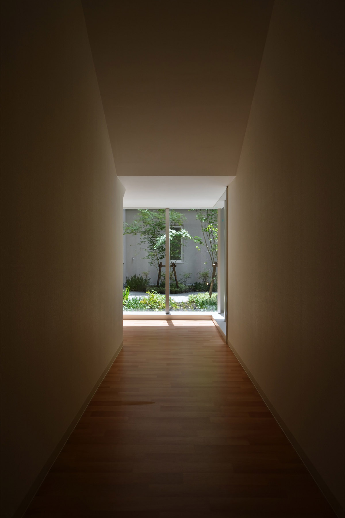 Nabari Intensive Nursing Home Courtyard enclosed by a corridor flooded with natural light.