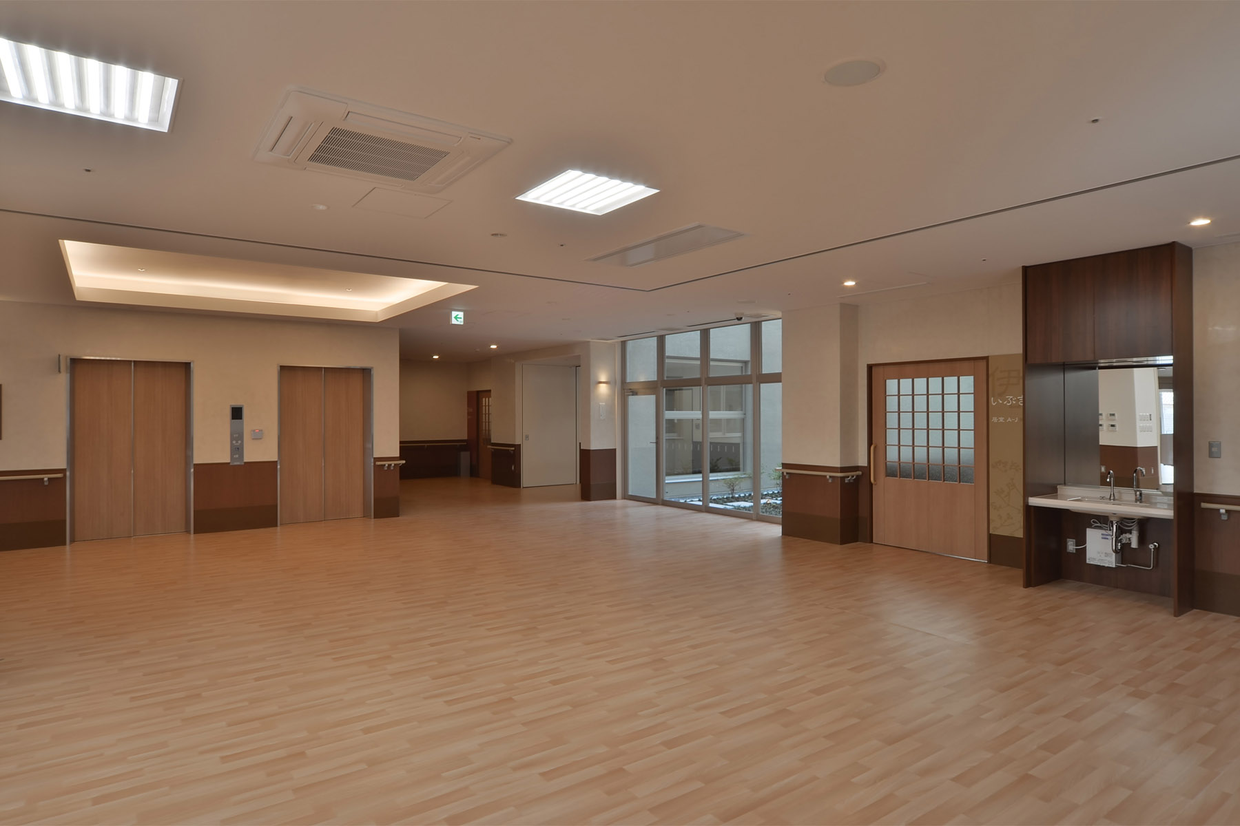 Nabari Intensive Nursing Home Courtyard enclosed by a corridor flooded with natural light.