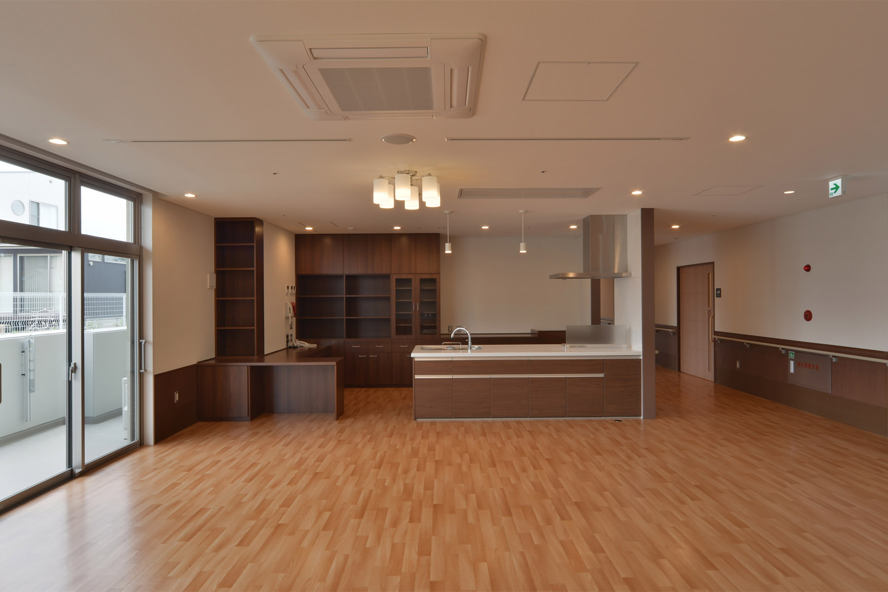 Nabari Intensive Nursing Home Courtyard enclosed by a corridor flooded with natural light.