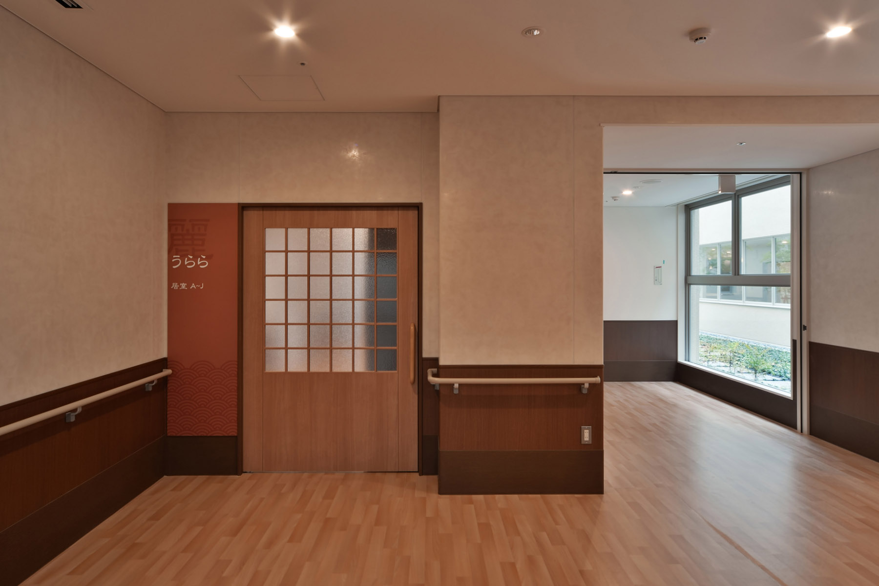 Nabari Intensive Nursing Home Courtyard enclosed by a corridor flooded with natural light.