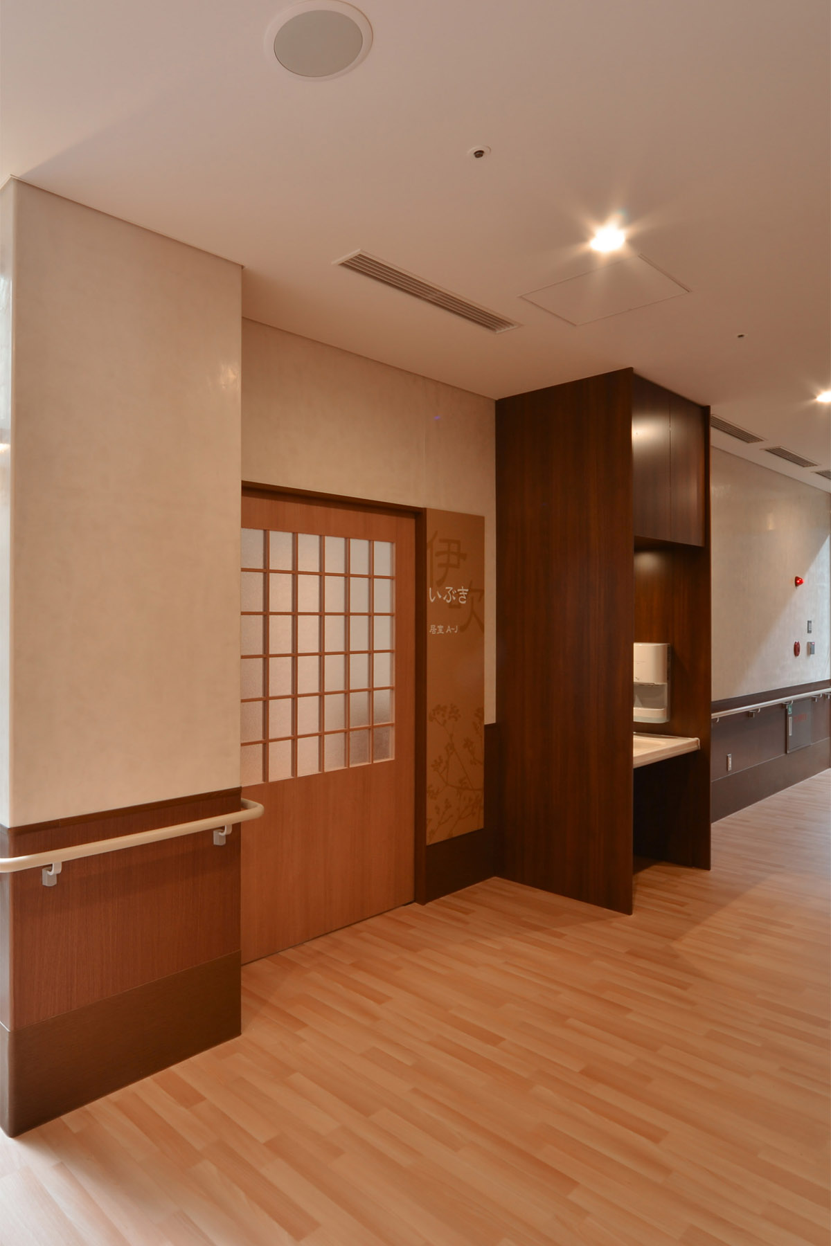 Nabari Intensive Nursing Home Courtyard enclosed by a corridor flooded with natural light.