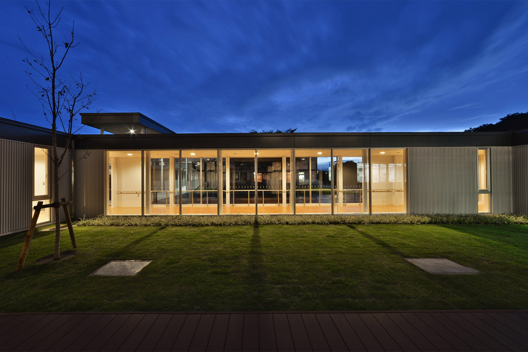 Nabari Intensive Nursing Home Courtyard enclosed by a corridor flooded with natural light.